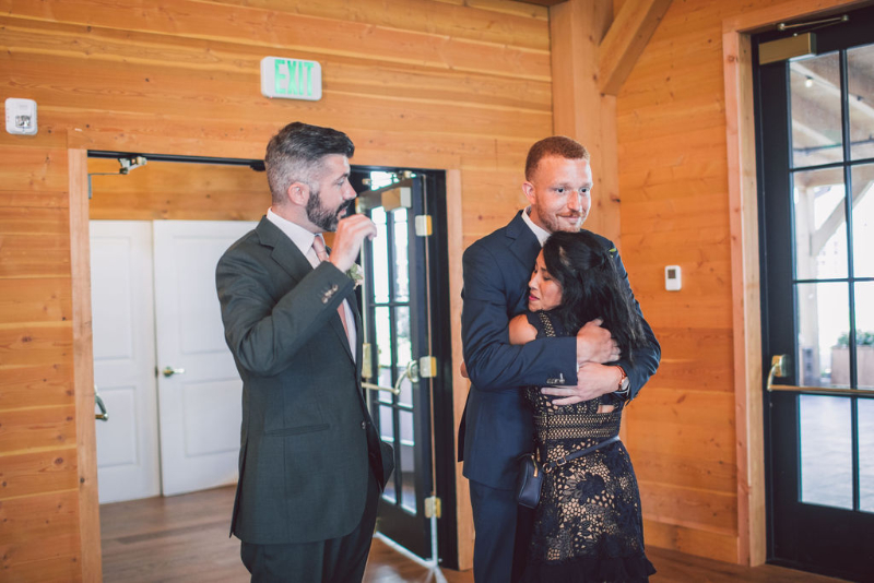 grooms hug wedding planner