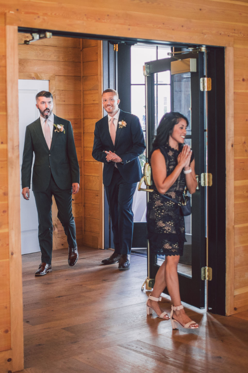 grooms walk into their wedding reception
