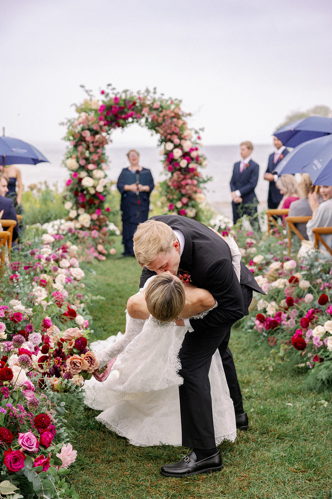 kiss in the aisle newlyweds at the lake house wedding 