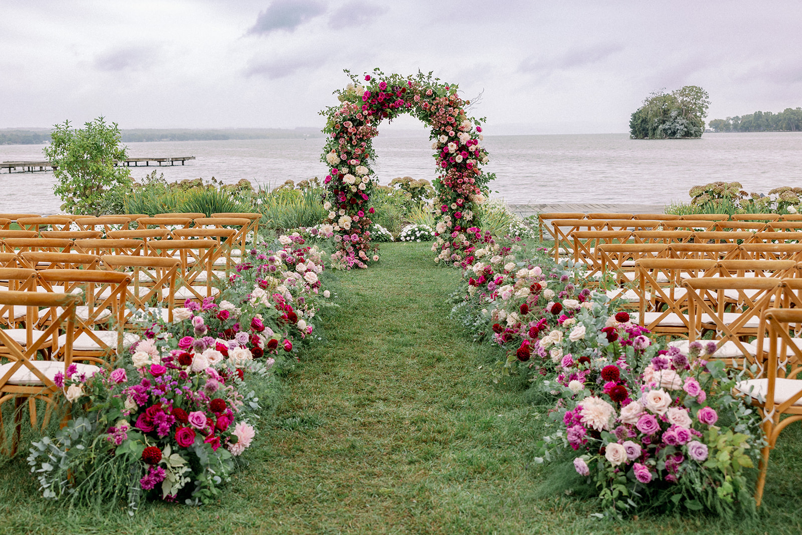 gorgeous lake side ceremony with pink florals and arch 