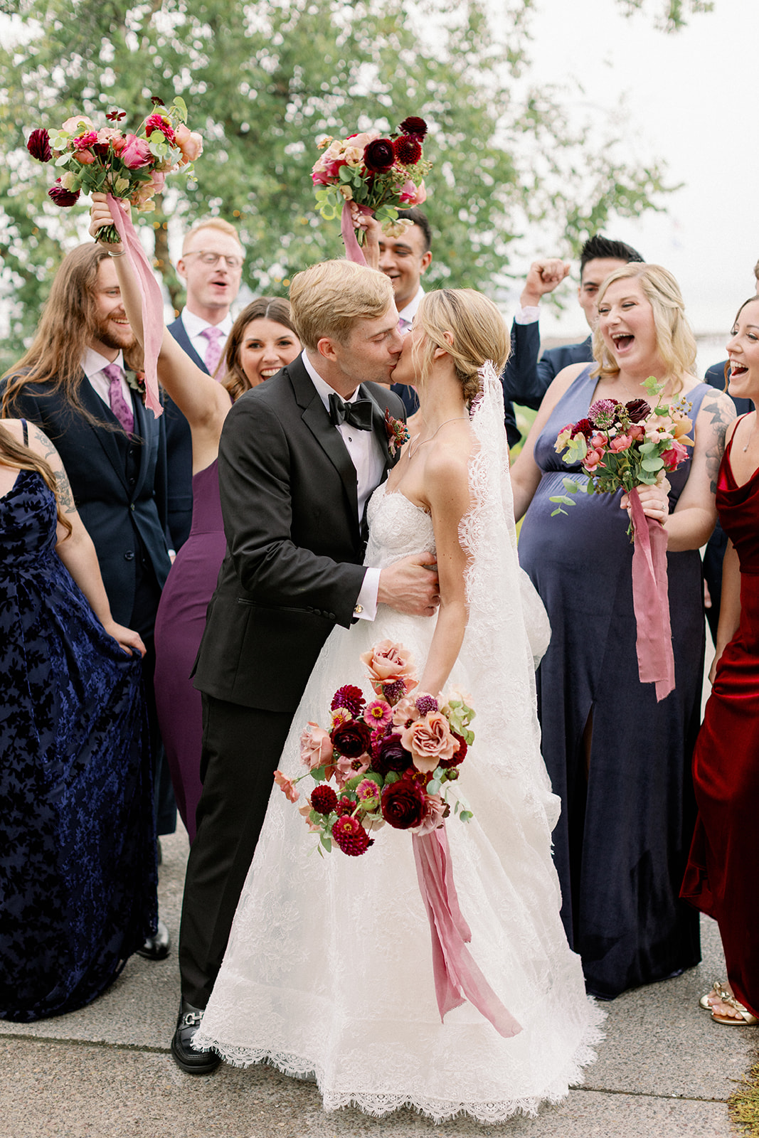 bride and groom kiss at their lake house wedding 