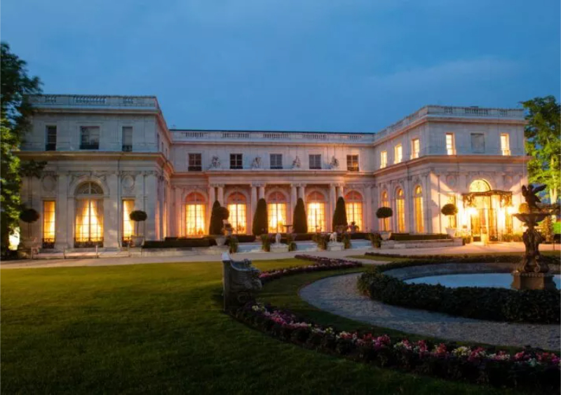 View of Rosecliff Mansion lit up at dusk.