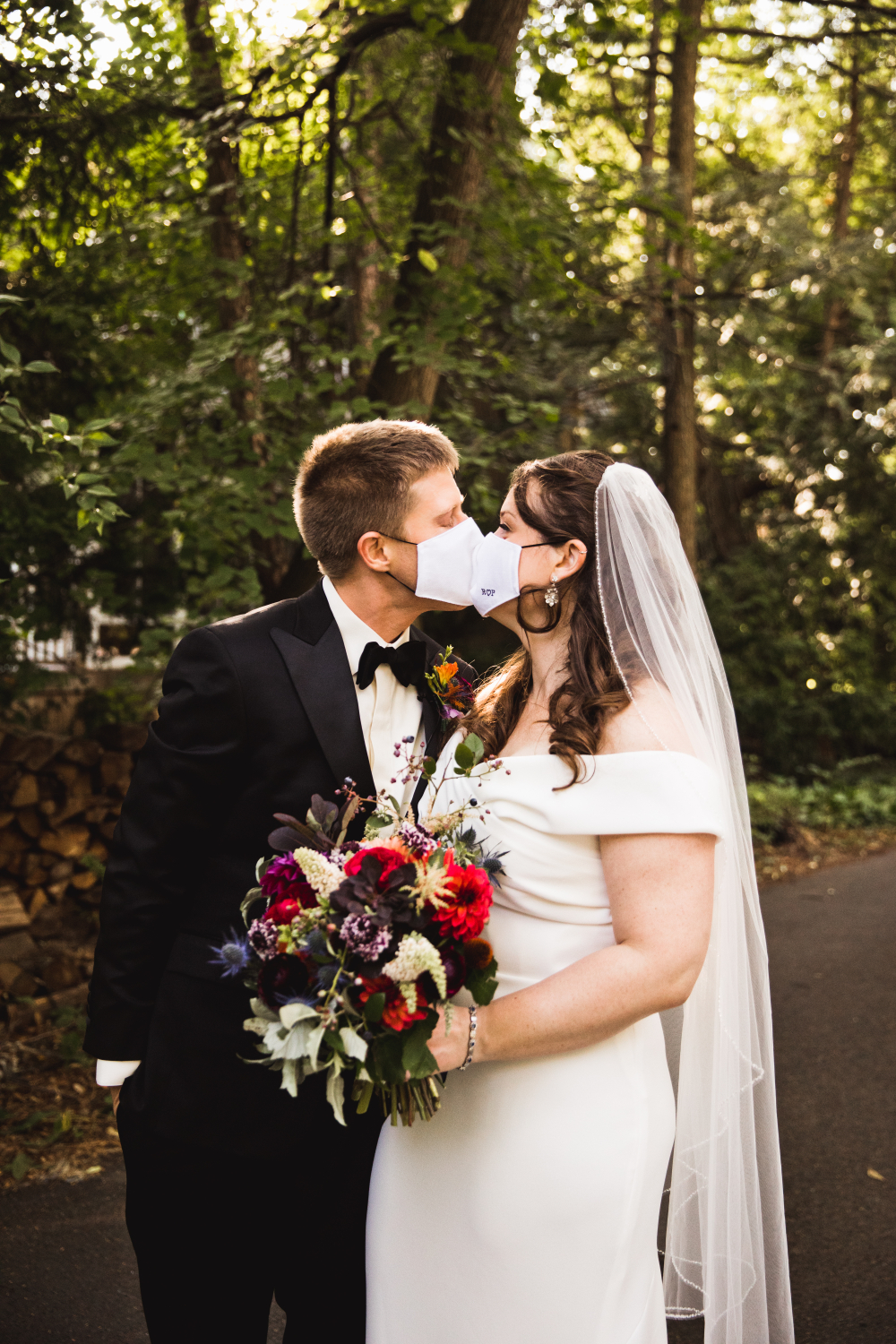 Bride and Groom Kissing through face masks
