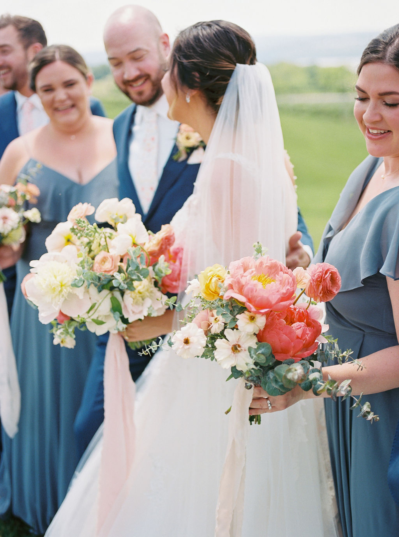 Bridesmaids holding spring bouquet florals