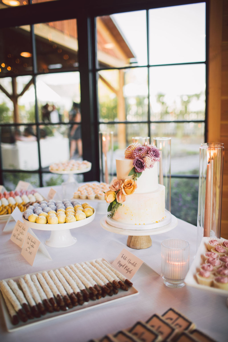 two tier wedding cake and dessert table