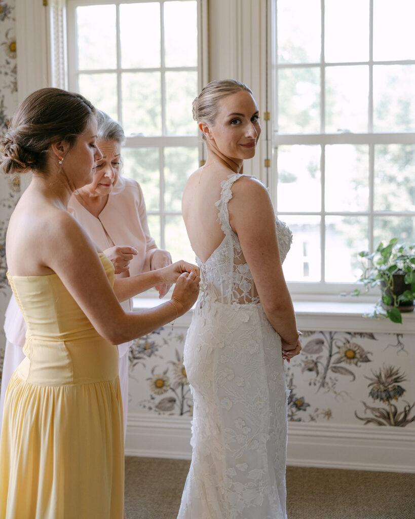 bride getting her dress on 