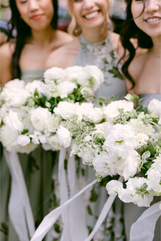 Bridesmaids holding bouquets and choosing flowers for your reception.