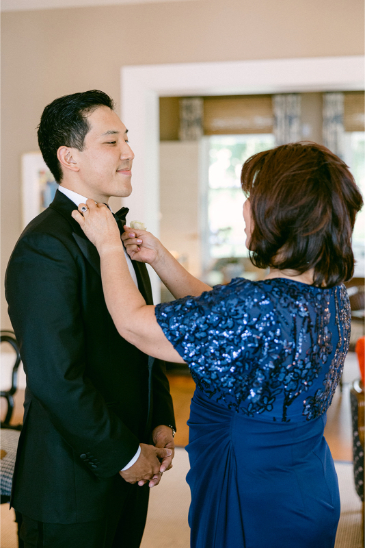 mother of the groom getting her son ready