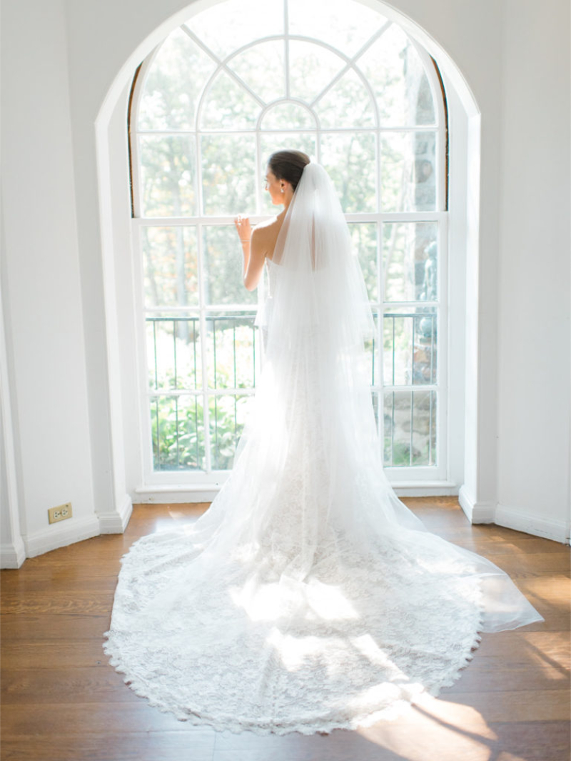 Bride at Glynwood standing in front of bright window. 