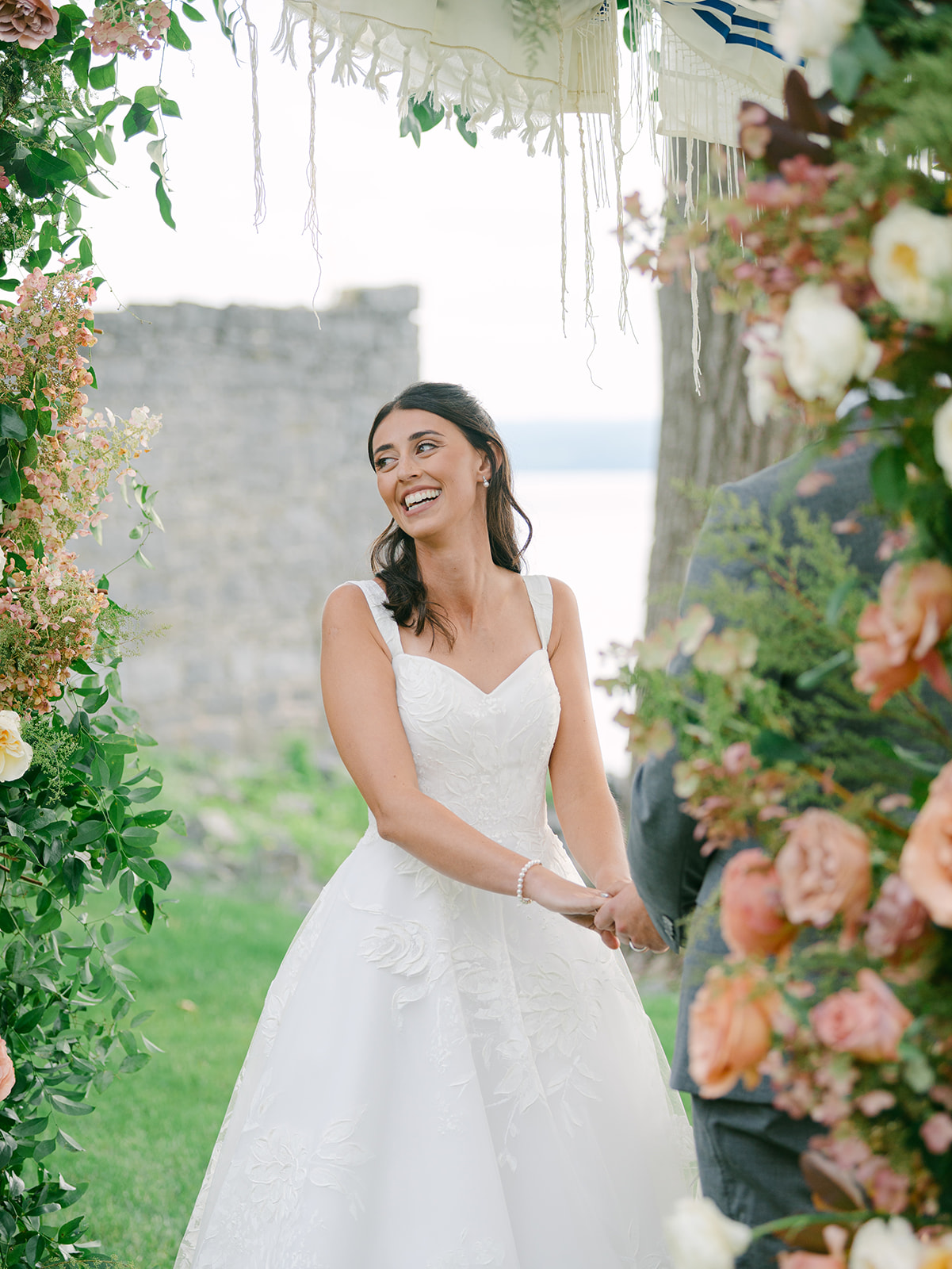 Bride smiles during wedding ceremony at Inns of Aurora.