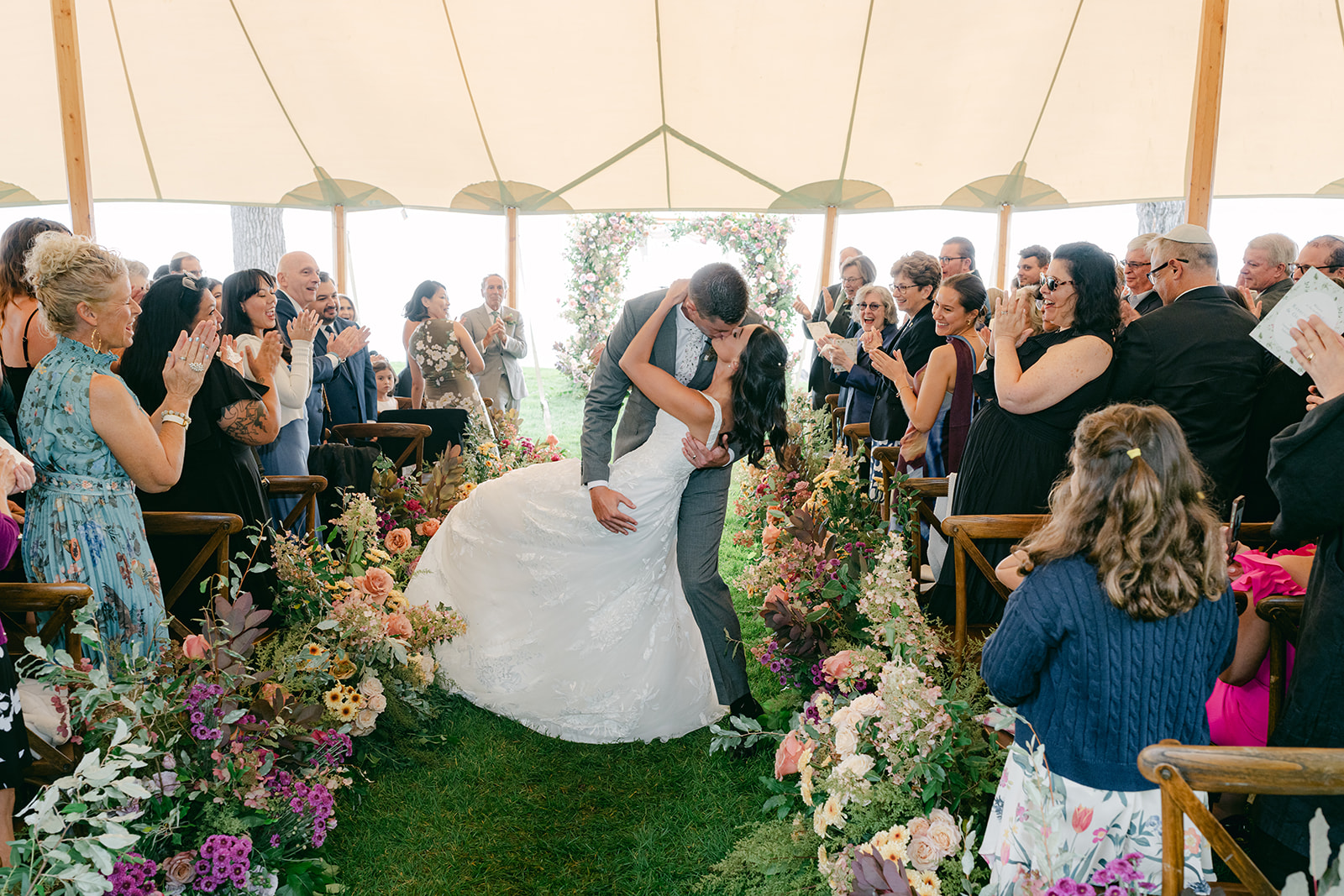Groom dips bride in the middle of the aisle during recessional.