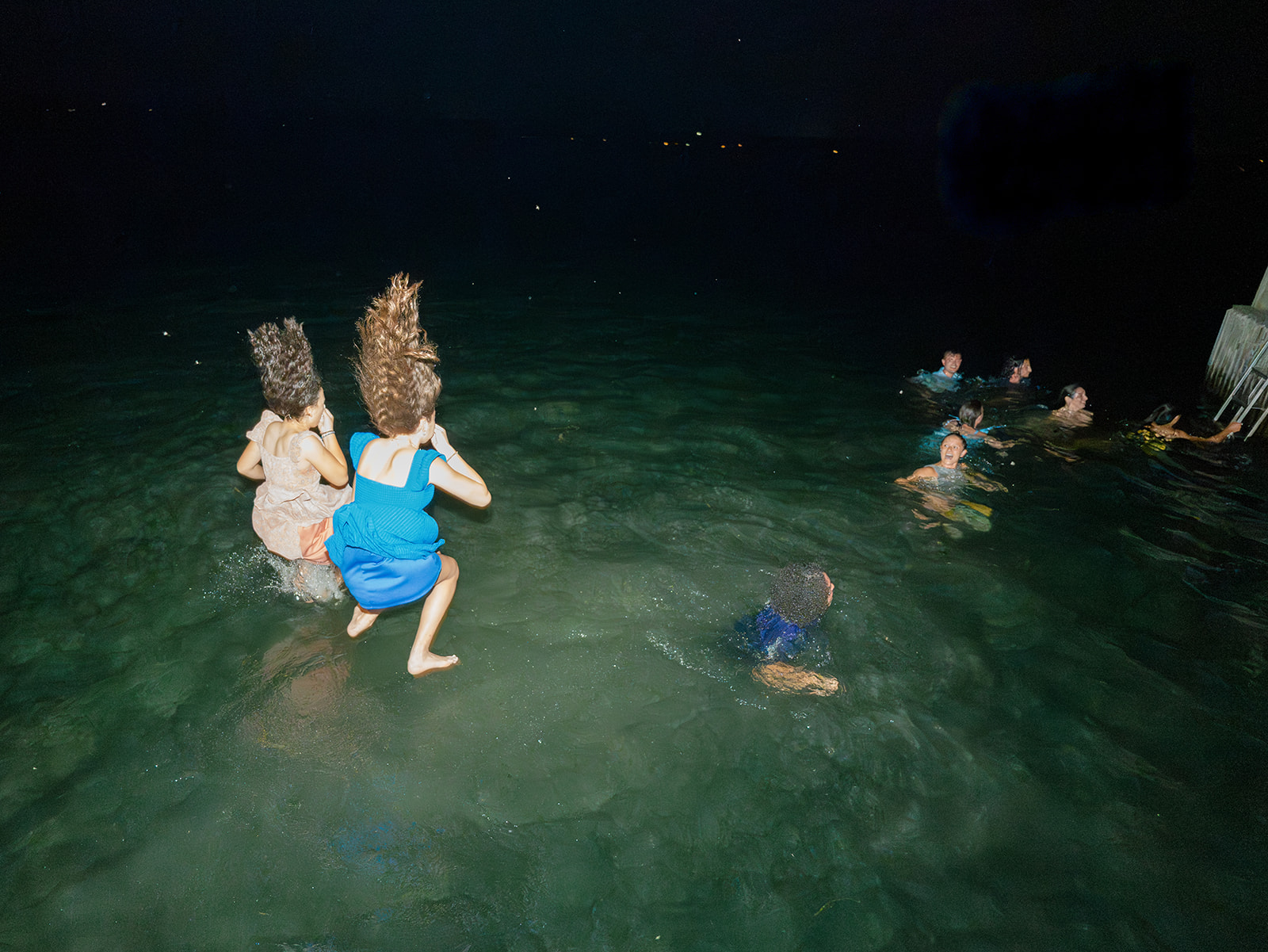 Guests jump into lake after welcome party at Inns of Aurora.