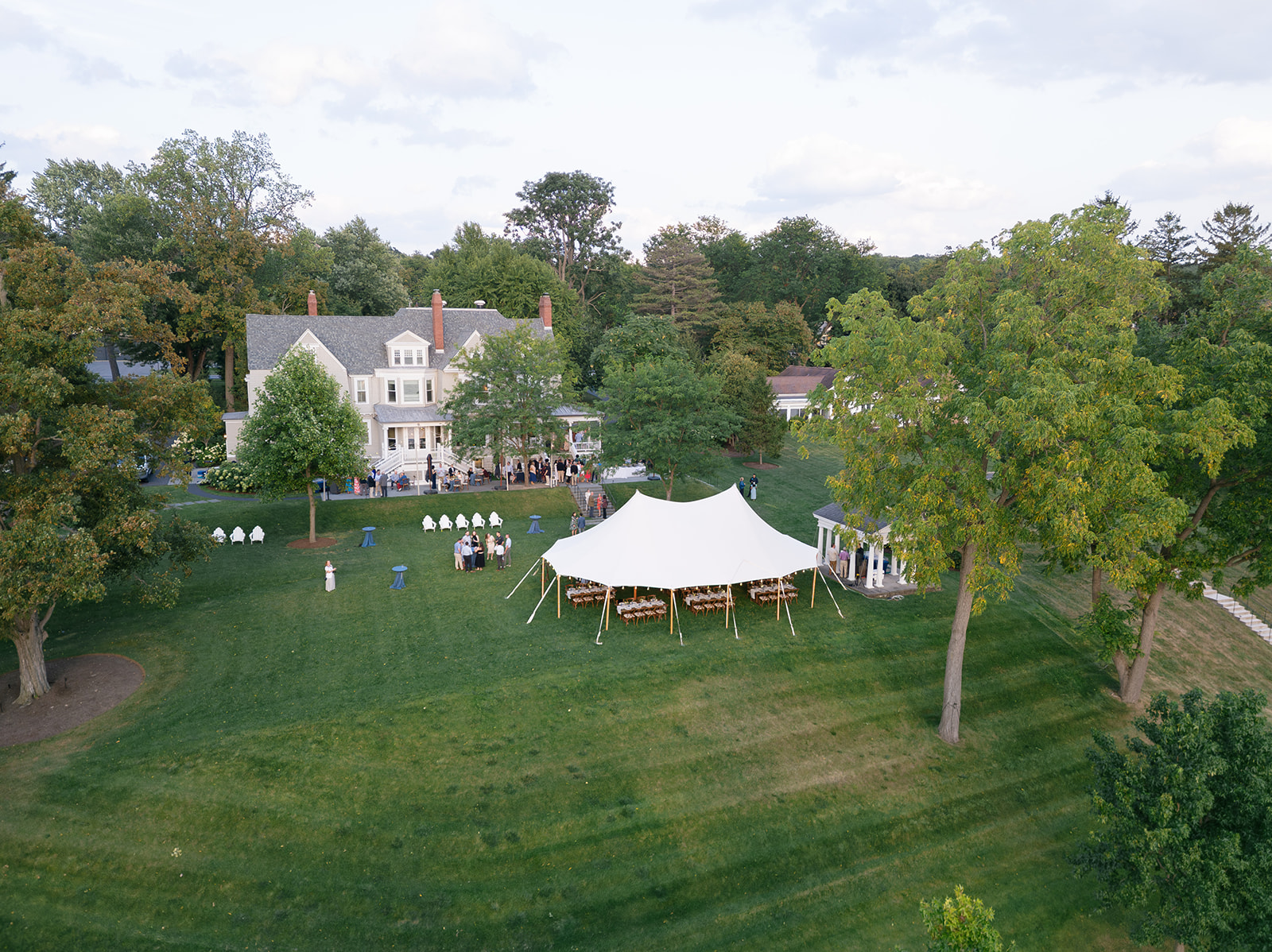 Aerial view of tented wedding welcome dinner at Inns of Aurora.
