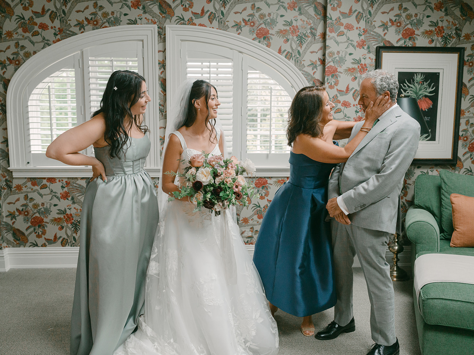 Family photo of bride with her mother, father and sister.