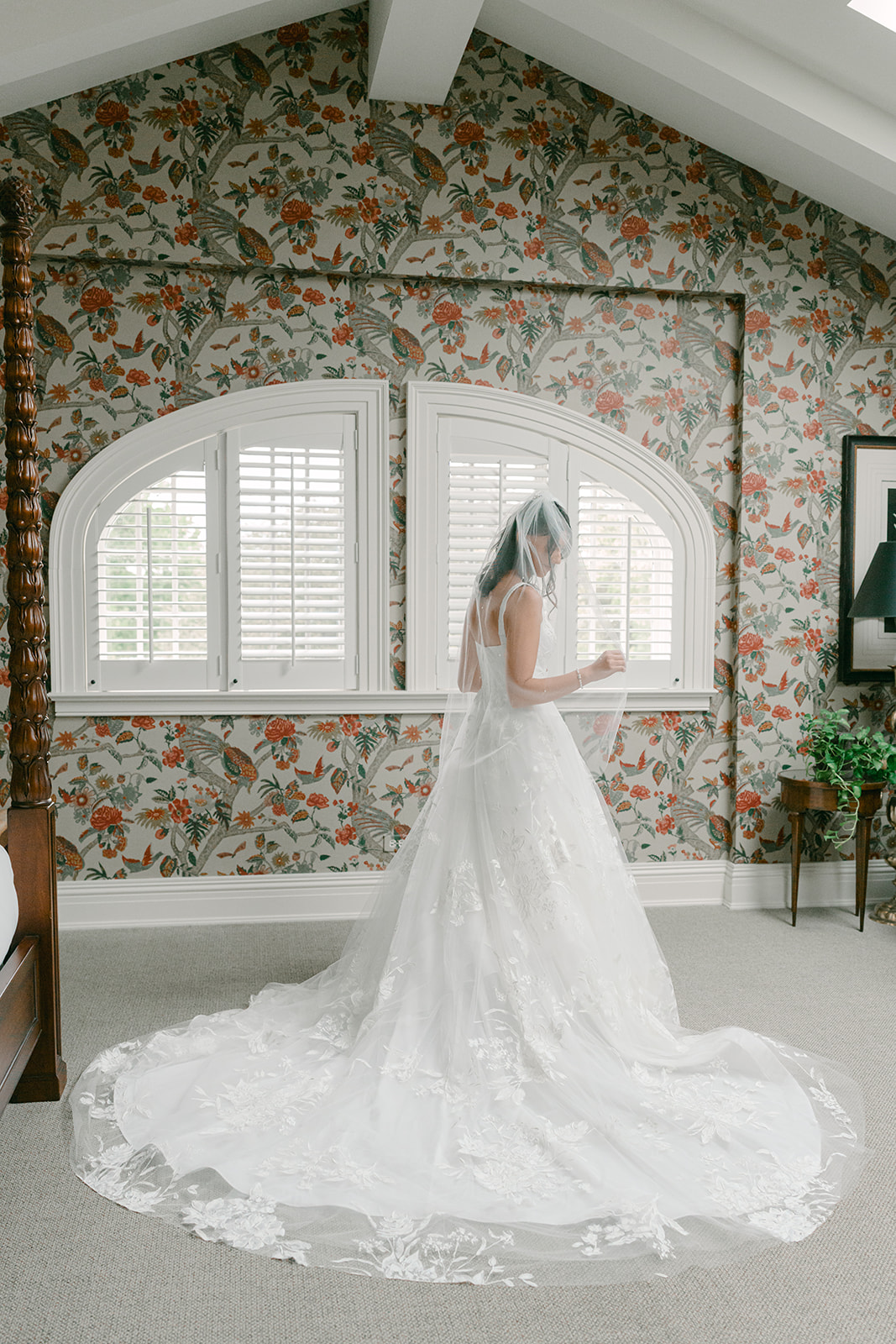 Bride stands as she gets ready for first look with her dad.