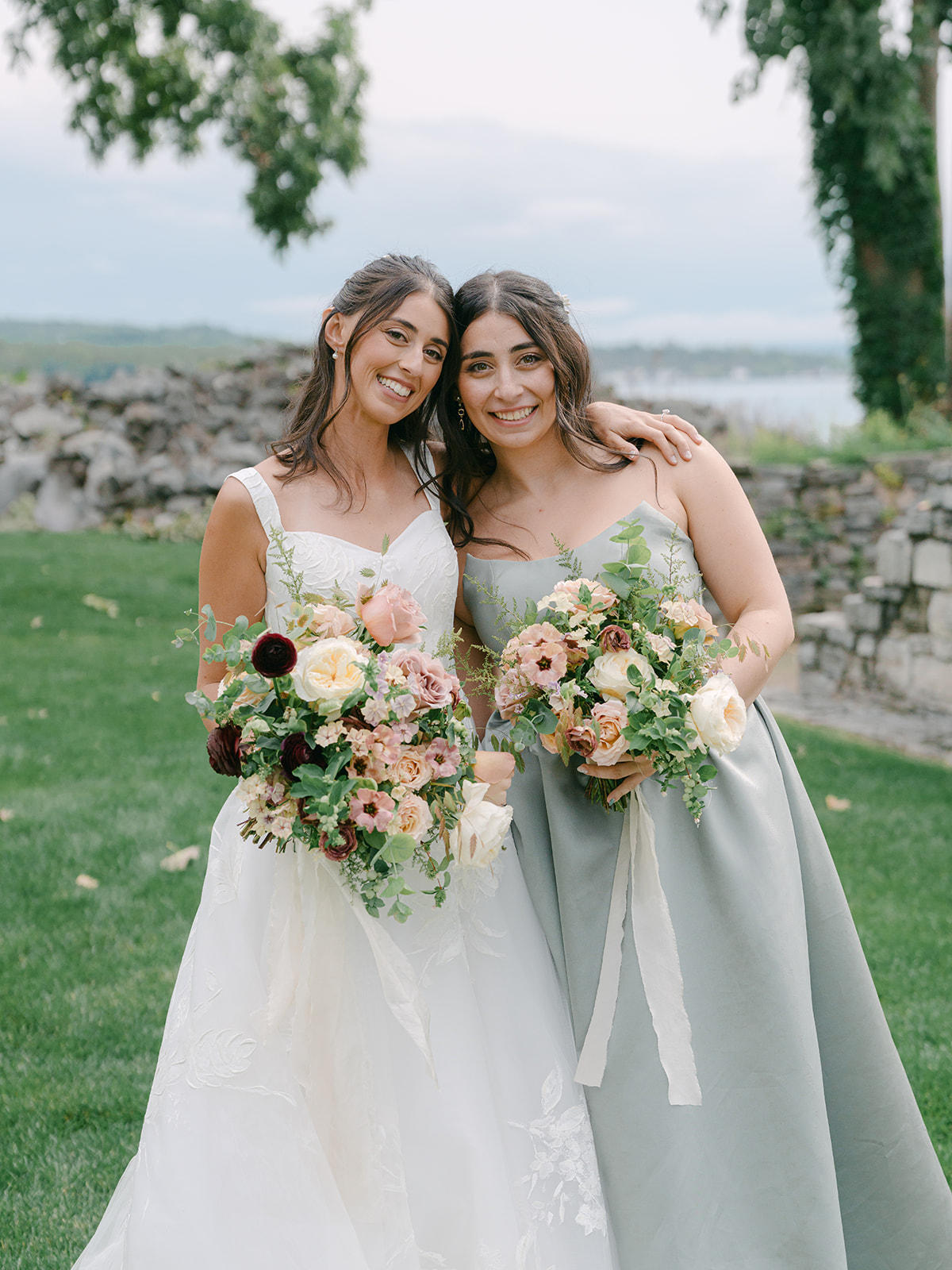 Bride and her sister pose together for photo at Inns of Aurora.