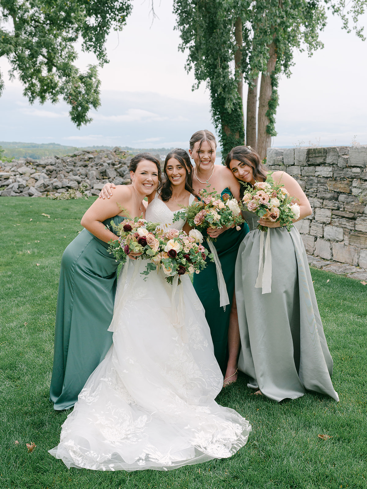 Bride poses with bridesmaids for photos at Inns of Aurora.