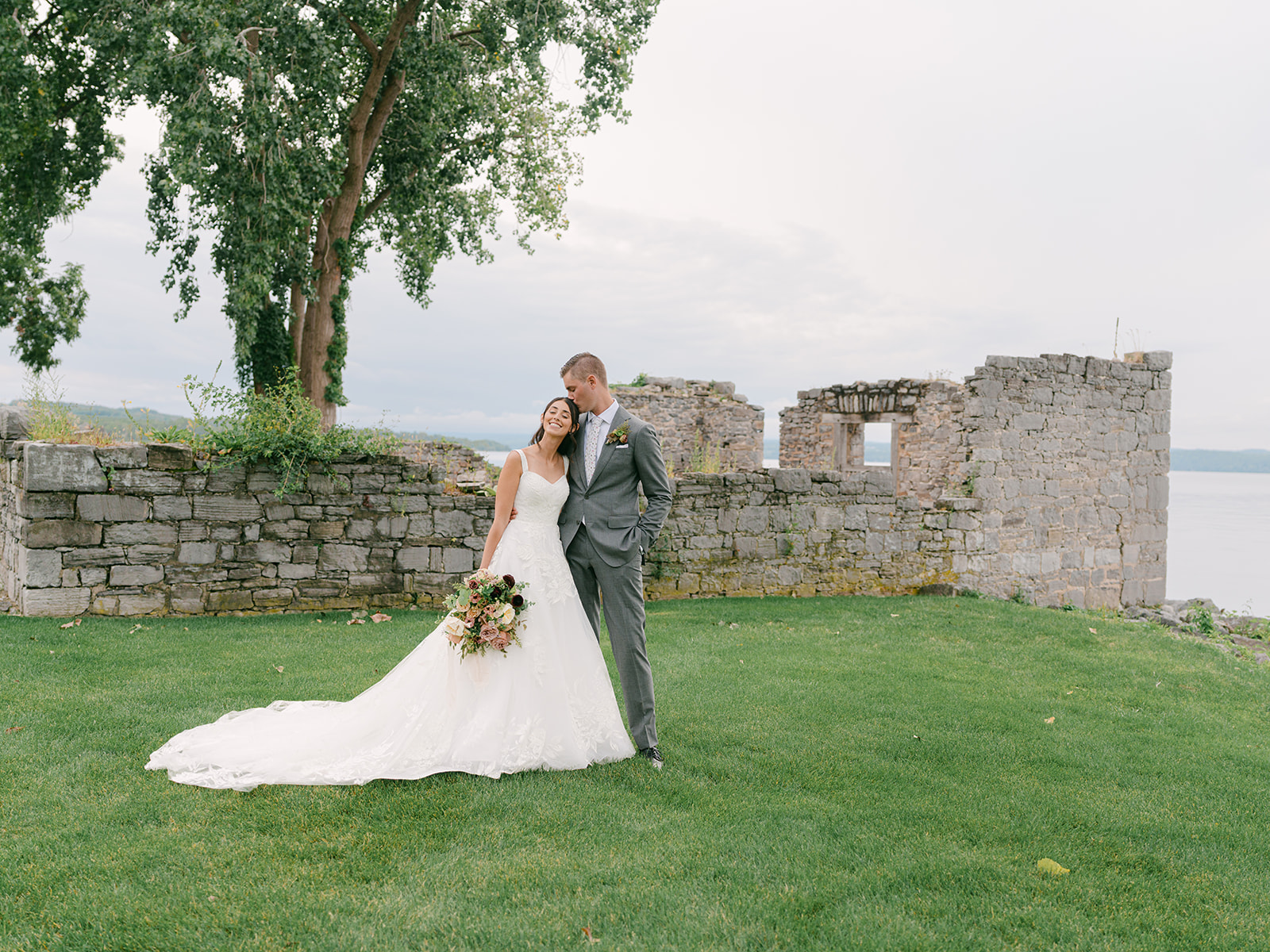 Bride and groom take portraits in ruins at Inns of Aurora.