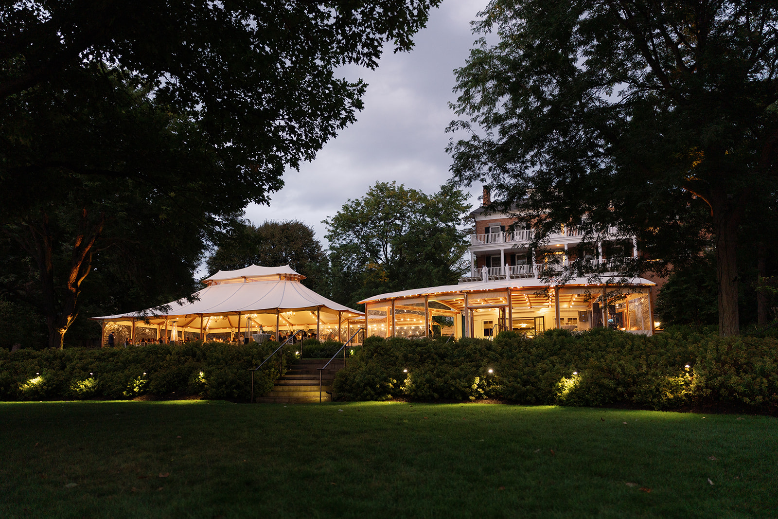 Inns of Aurora lit up at night for reception with a fall wedding design.