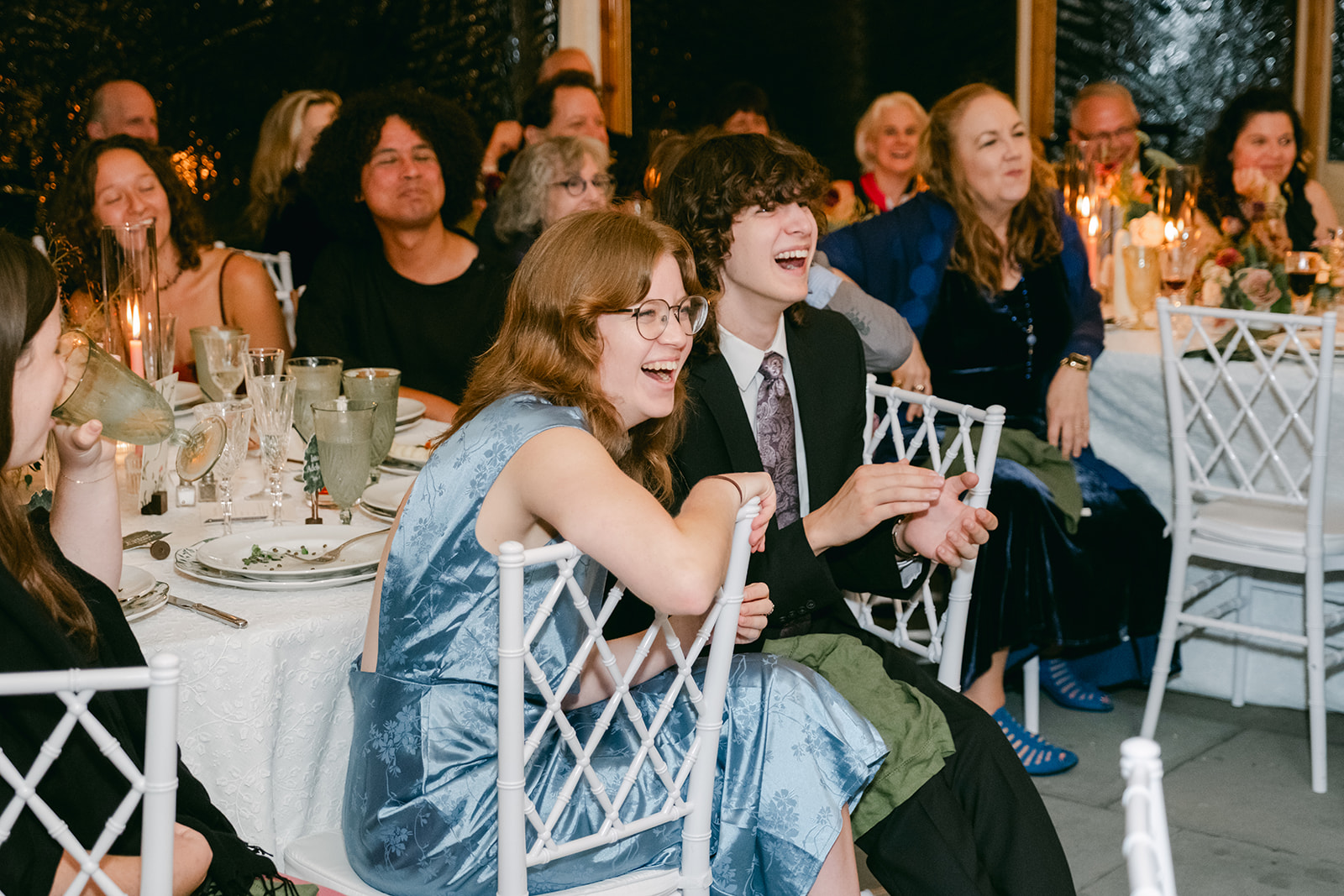 Guests laughing during speeches at Inns of Aurora wedding.
