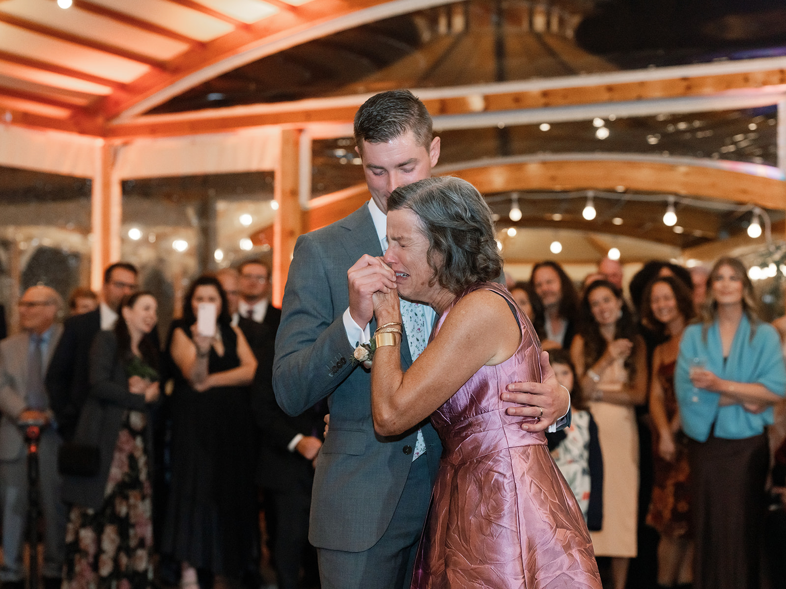 Groom shares emotional dance with his mother at Inns of Aurora wedding.
