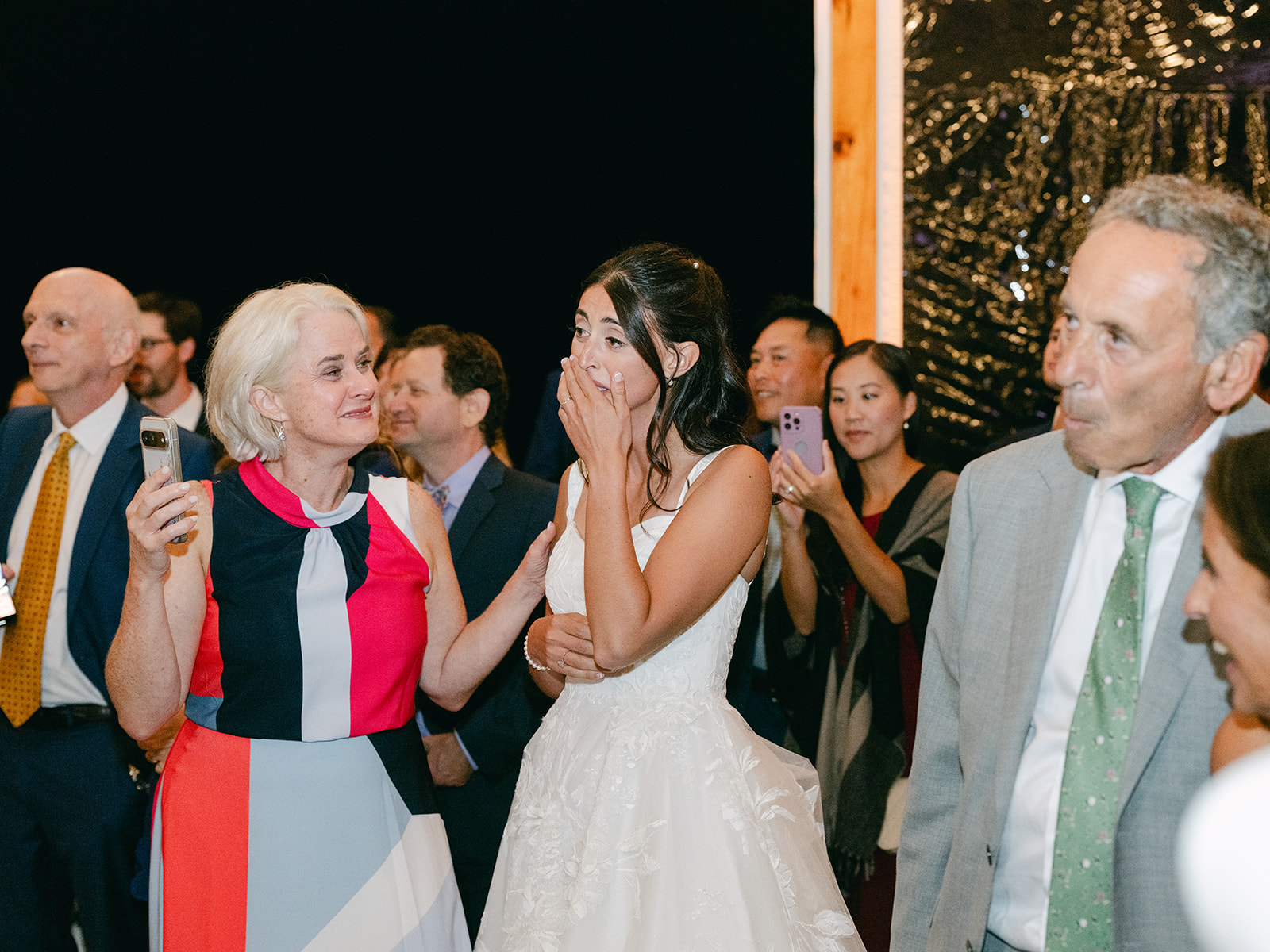 Bride surprised by her family during reception at Inns of Aurora.
