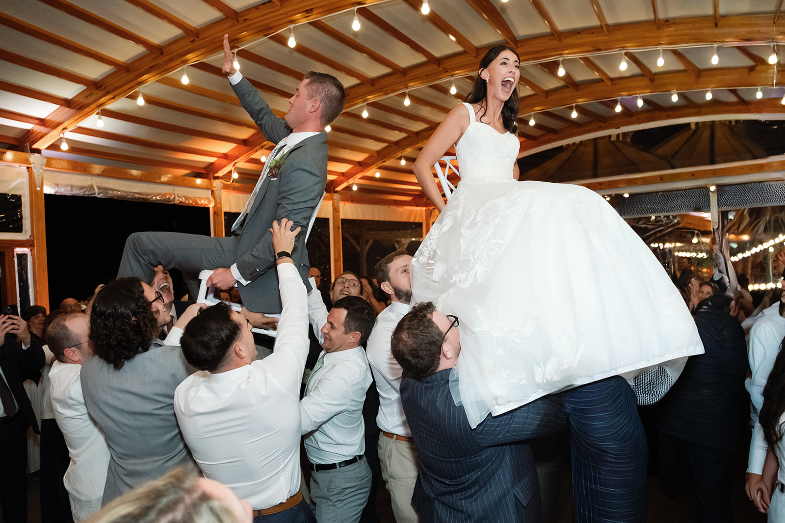 Bride and groom lifted up for Horah.
