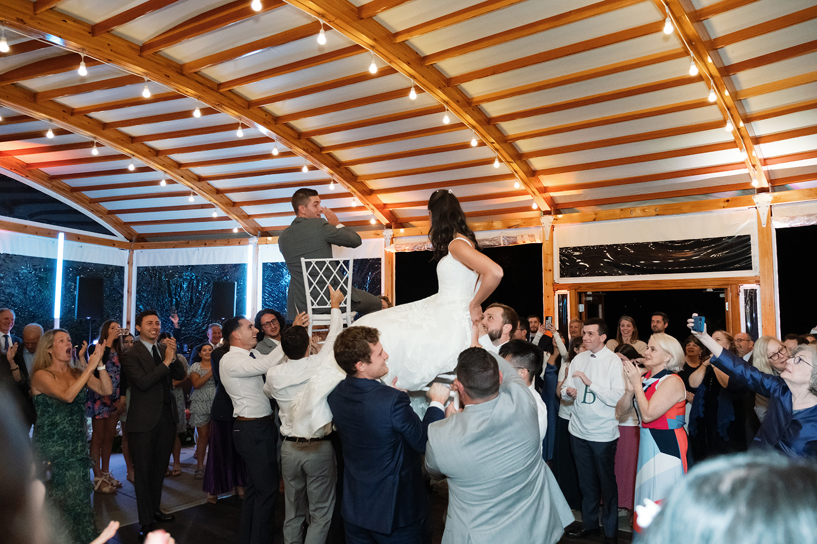 Bride and groom lifted up for Horah.
