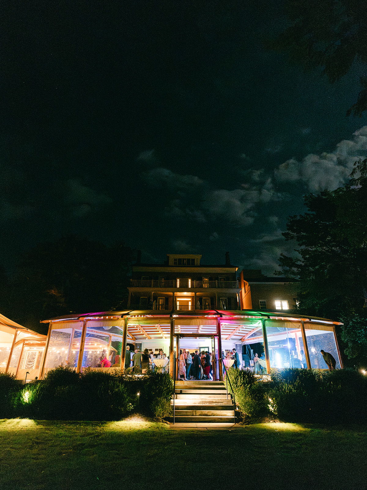 Inns of Aurora lit up at night for reception with a fall wedding design.