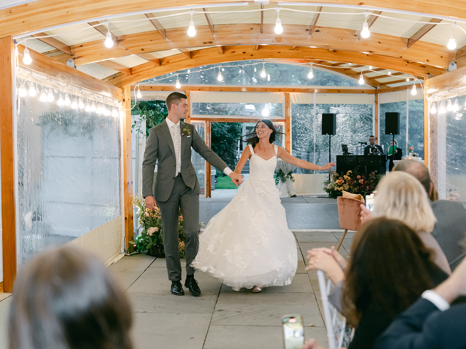 Bride and groom make grand entrance to wedding reception at Inns of Aurora.