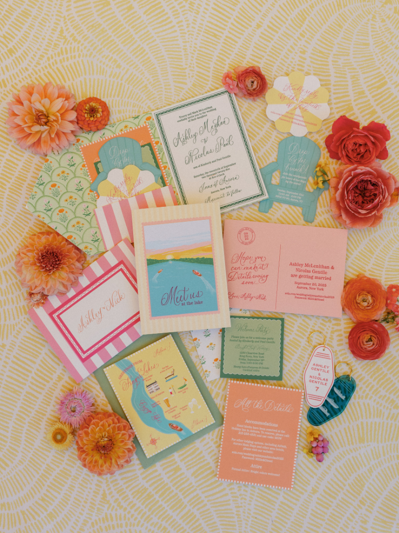 Slim Aarons inspired wedding stationary arranged in flatlay with florals.