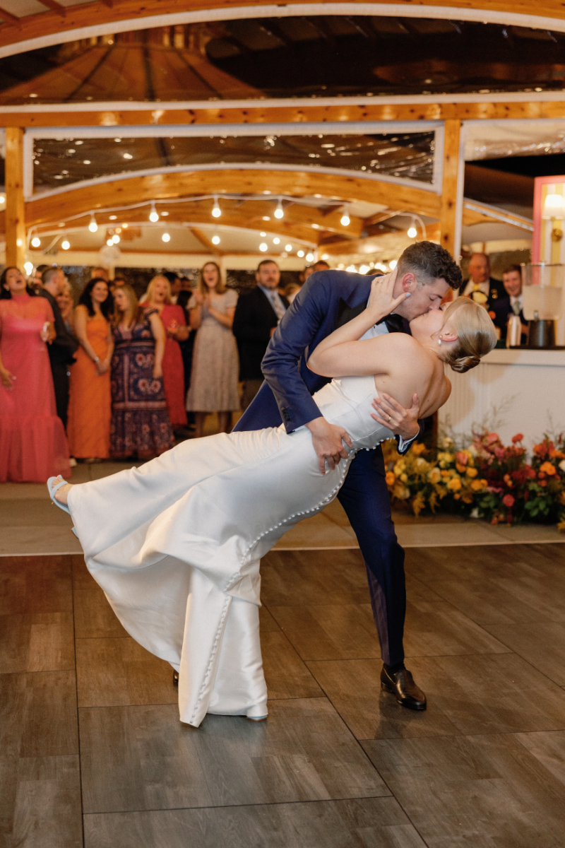 Bride and groom share first dance during wedding reception.