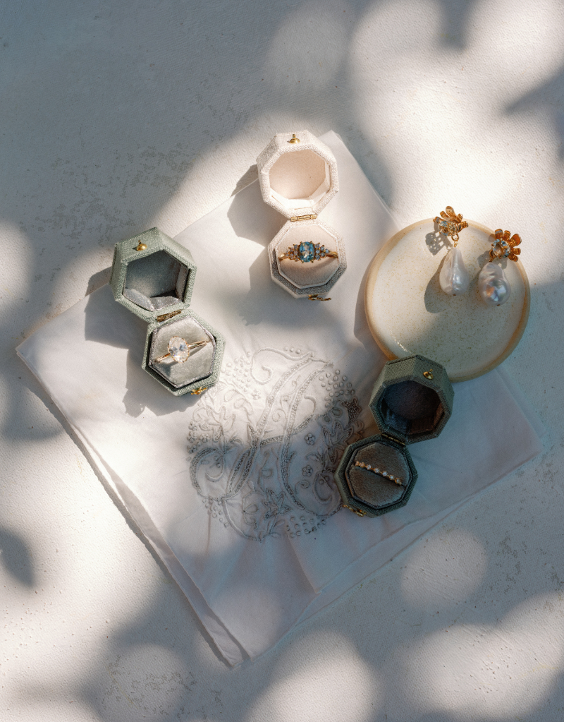 Flat lay of wedding rings and jewelry.