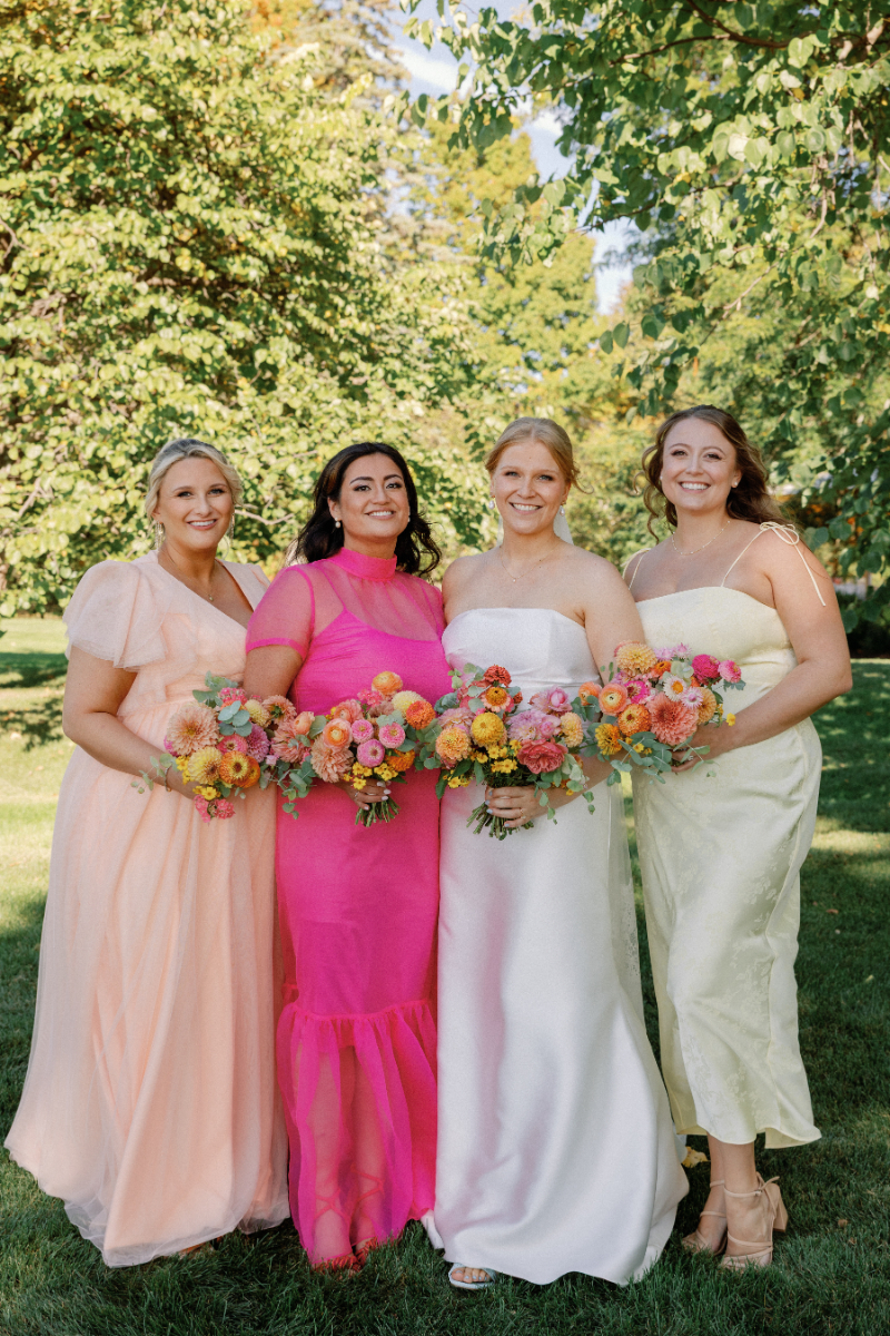 Bride standing with her bridesmaids on the lawn.