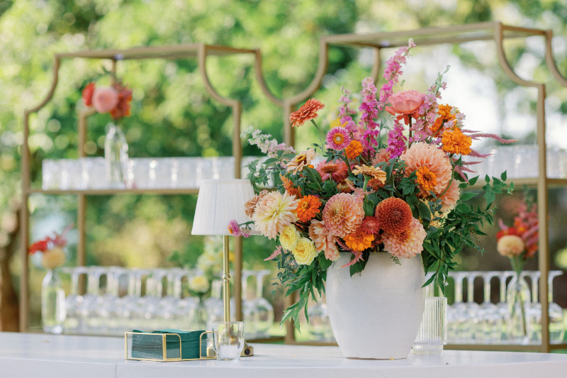 Bold, colorful floral arrangement for cocktail hour bar.