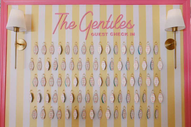 Custom boat key chain as escort card hanging from display.