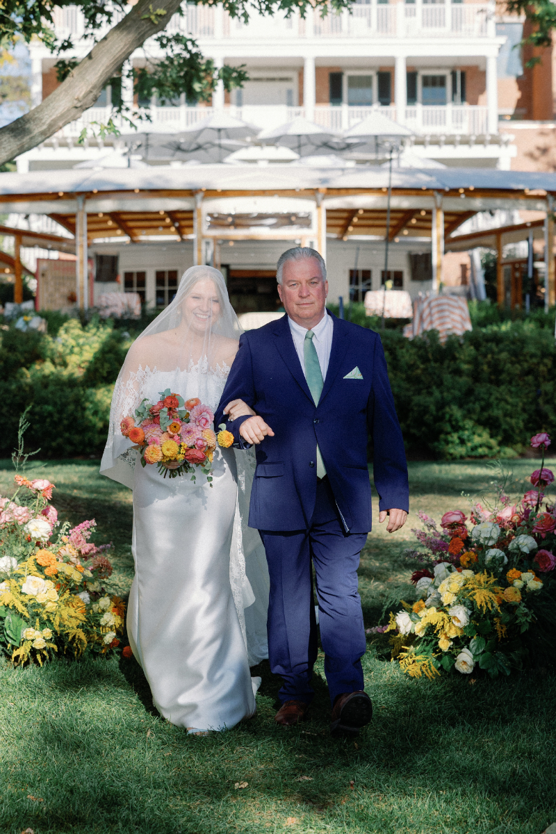 Bride walks down the aisle with her father.