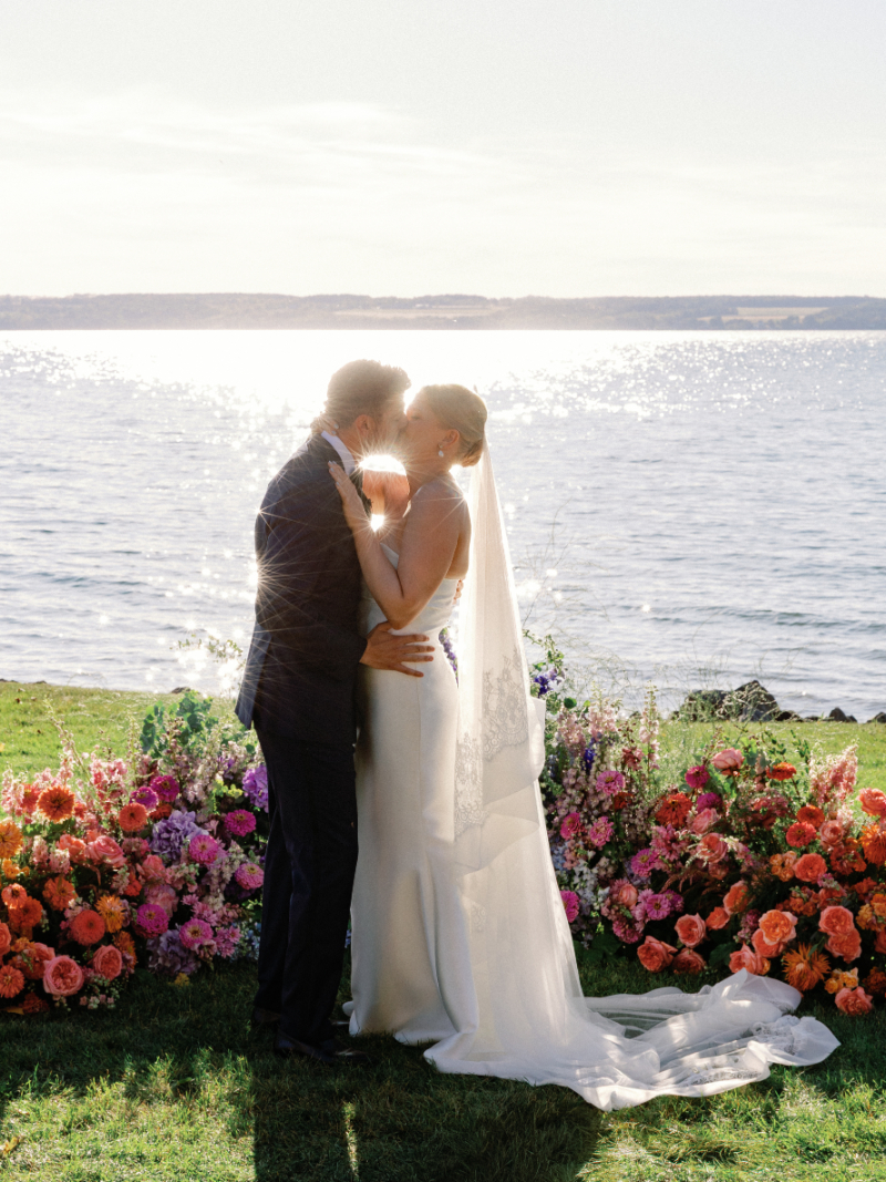 Bride and groom share kiss during wedding ceremony.