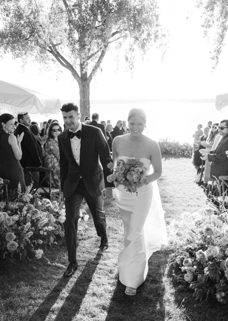 Bride and groom exit ceremony, ecstatic.