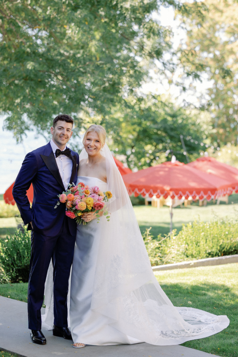 Bride and groom stand for portrait after wedding ceremony.