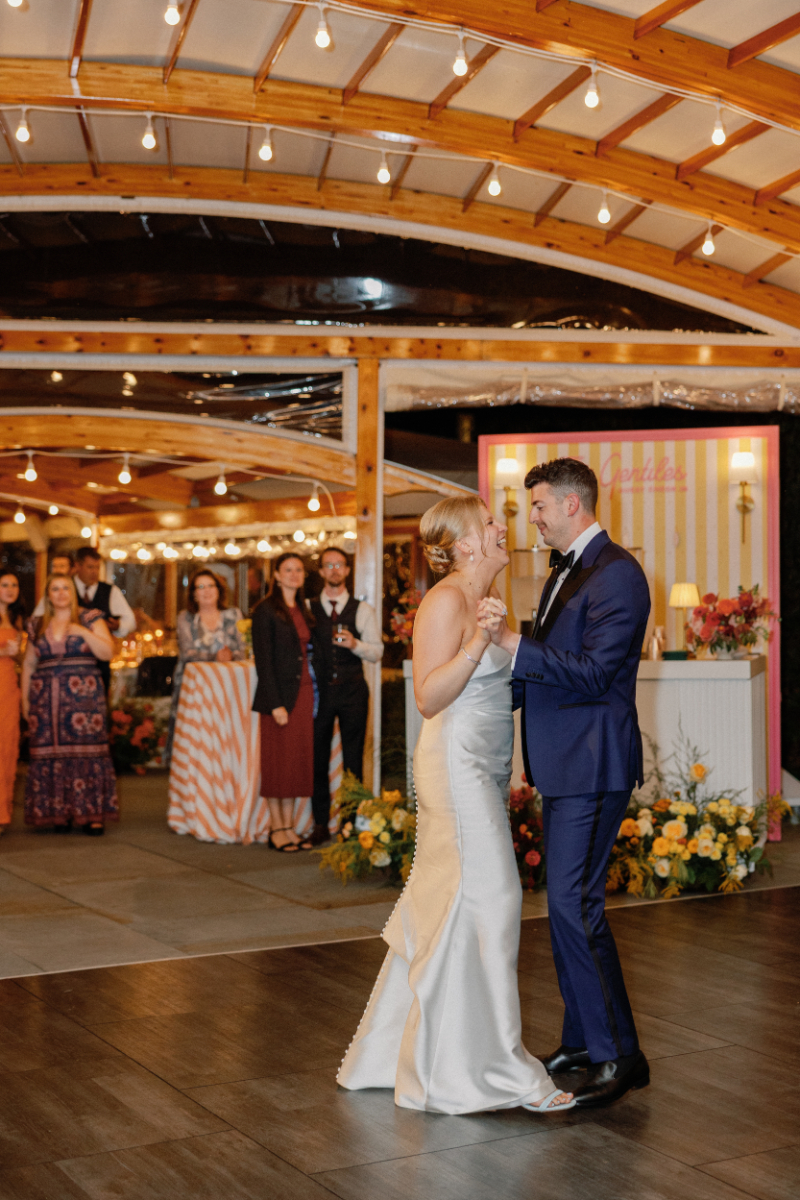 Bride and groom share first dance during wedding reception.
