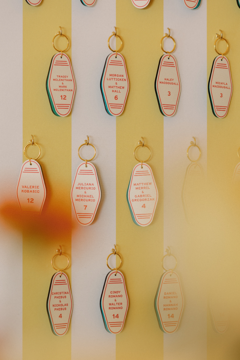 Custom boat key chain as escort card hanging from display.