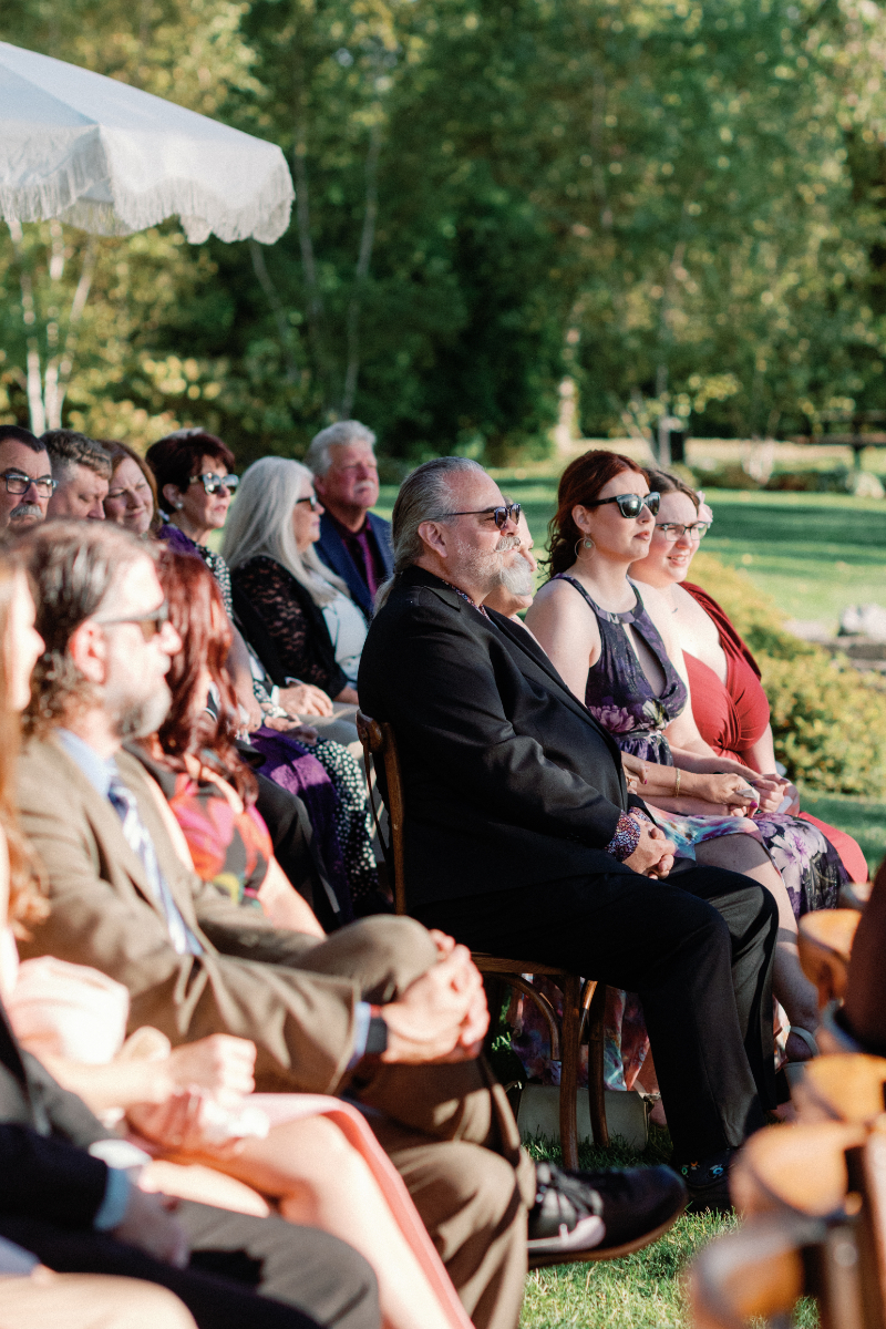 Guests watching as bride and groom exchange vows.