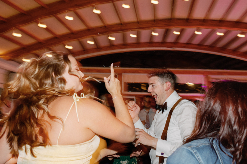 Groom dancing the night away during wedding reception.