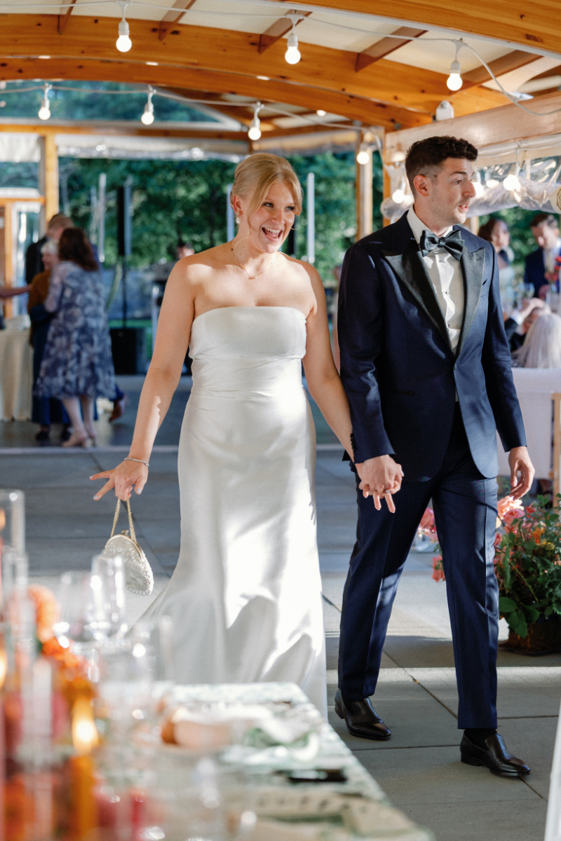 Bride and groom entering reception space for the first time as they do a grand reveal of the design.