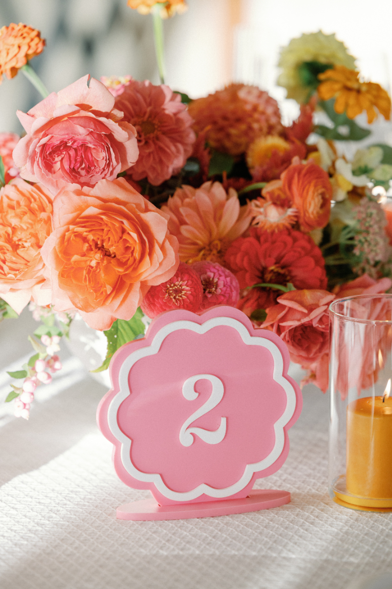 Floral details and custom scalloped table number for Slim Aarons inspired wedding reception.