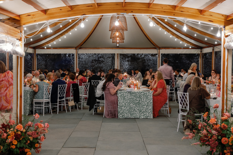 Guests seated for dinner under the Inns of Aurora tent.