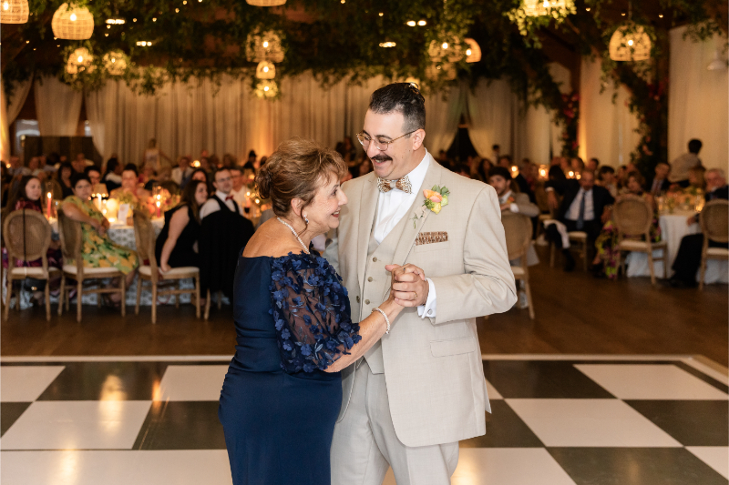 Groom shares dance with his mother on custom monogrammed dance floor.