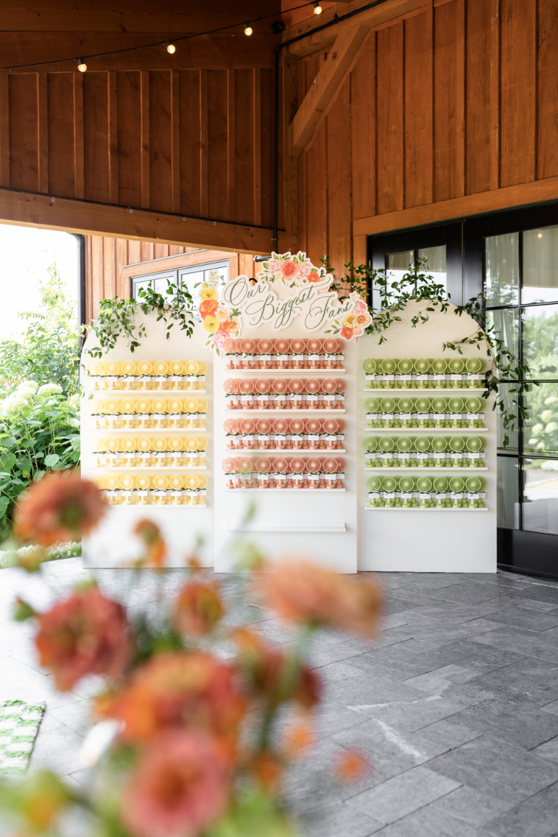 Colorful fan favors ready for guests to grab for outdoor summer camp wedding ceremony.