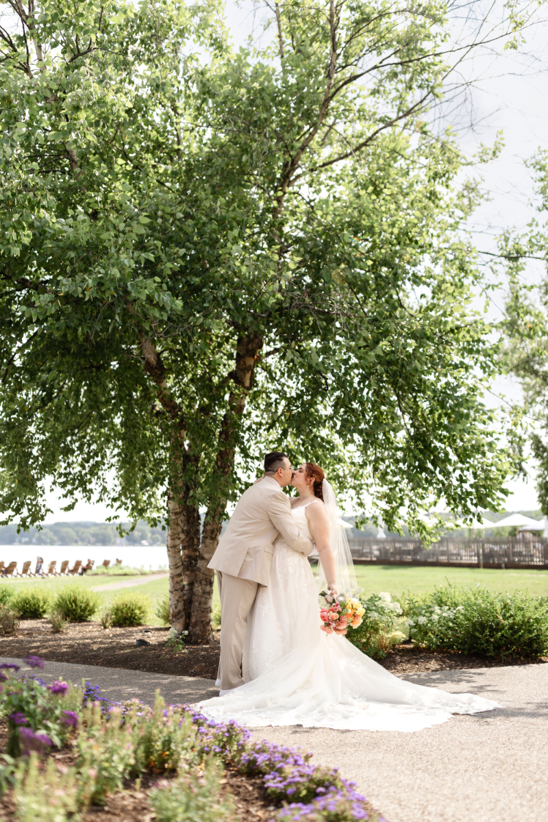 Bride and groom pose for portraits before summer camp wedding ceremony at the Lake House on Canandaigua.